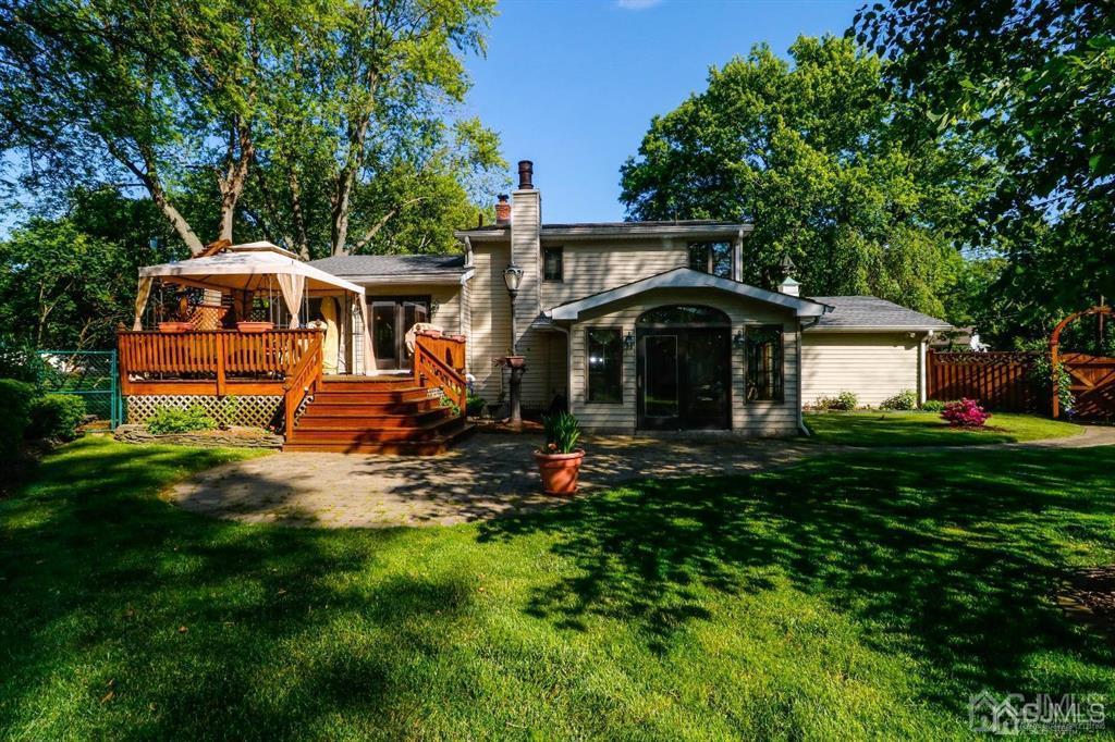 164 Devon Road Colonia, NJ 07067 - Photo 37 of 42 a front view of a house with a yard