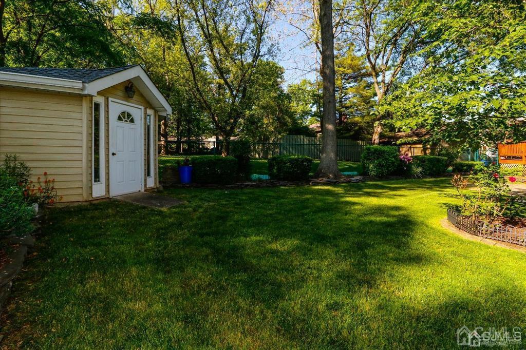 164 Devon Road Colonia, NJ 07067 - Photo 38 of 42 a front view of a house with yard and green space