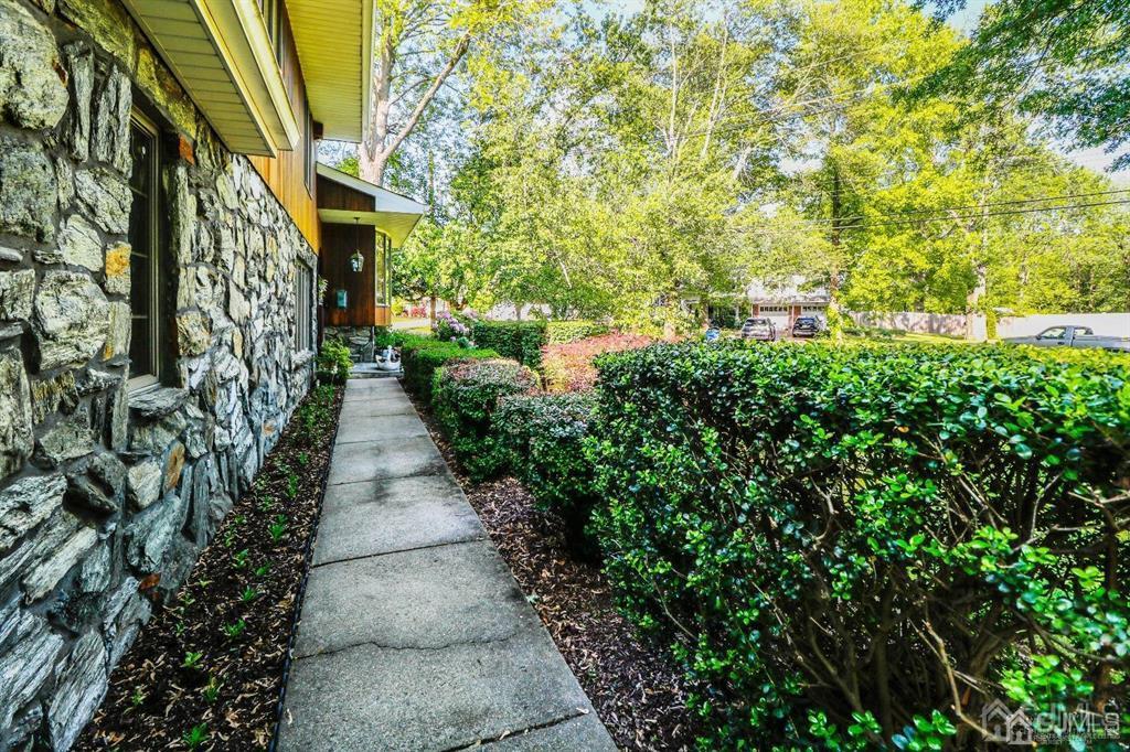 164 Devon Road Colonia, NJ 07067 - Photo 4 of 42 a view of a pathway both side of the house