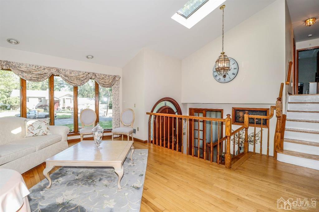 164 Devon Road Colonia, NJ 07067 - Photo 10 of 42 a view of a living room with a floor to ceiling window and stairs