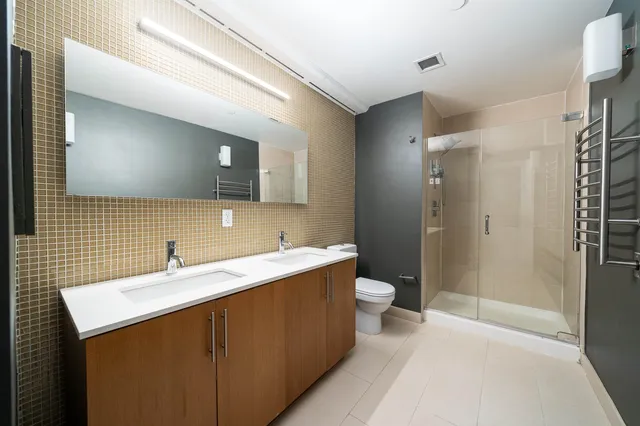 a bedroom with a bed and a potted plant