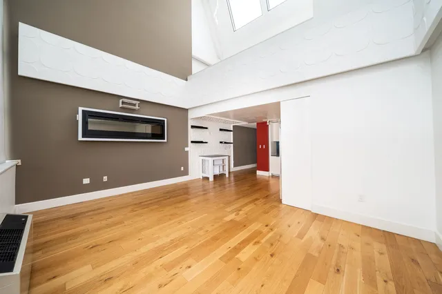 a view of empty room with a computer on a desk
