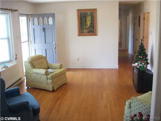 7384 Adams Farm Road Mechanicsville, VA 23111 - Photo 2 of 11 a living room with furniture and a potted plant