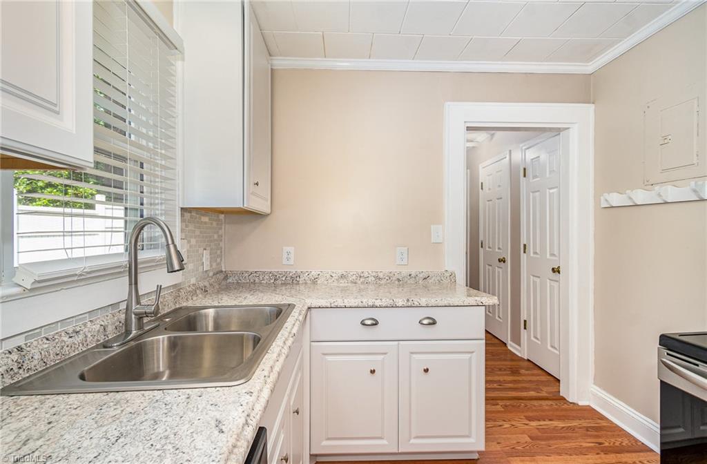 208 Rockspring Drive Thomasville, NC 27360 - Photo 11 of 28 newly remodeled kitchen with new counter tops, cabinets, backsplash and all appliances convey