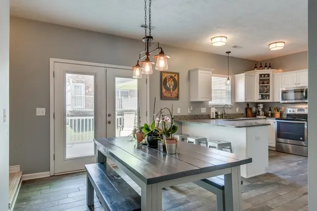 a kitchen with counter space dining table and chairs