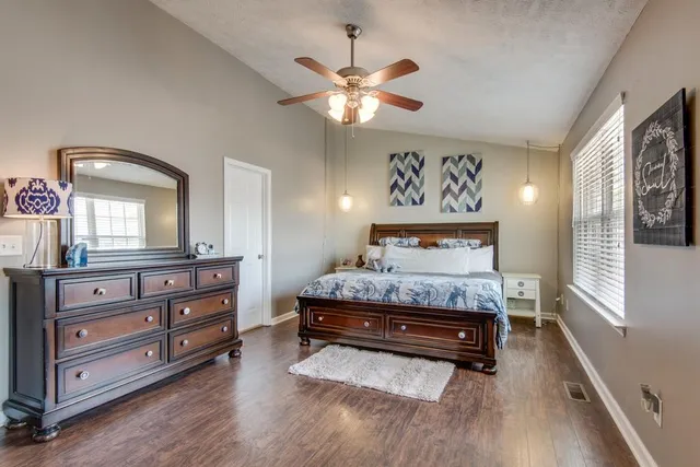 a bedroom with a bed and a mirror on dresser