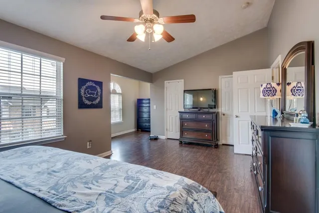 a bedroom with furniture and a flat screen tv
