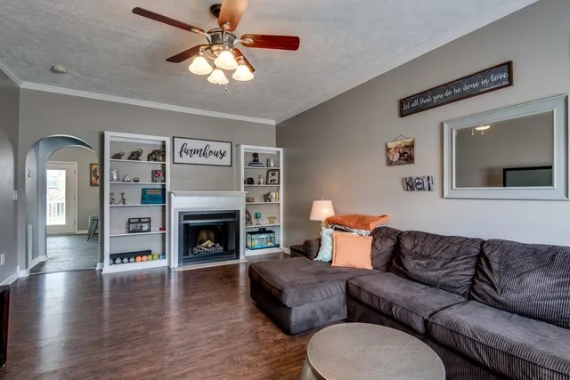 a living room with furniture fireplace and window