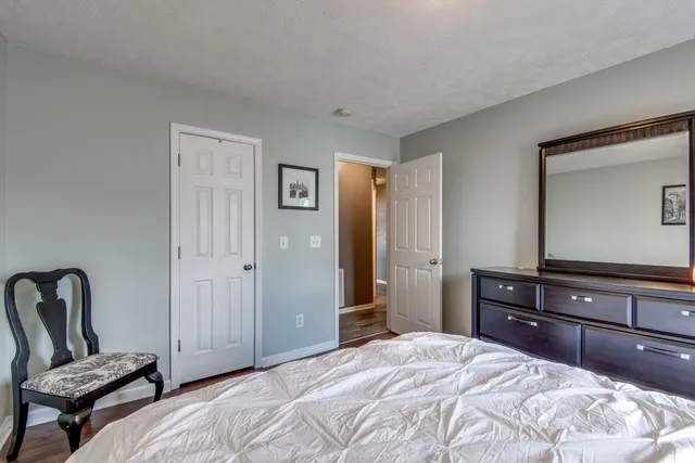 a bedroom with a bed and a dresser