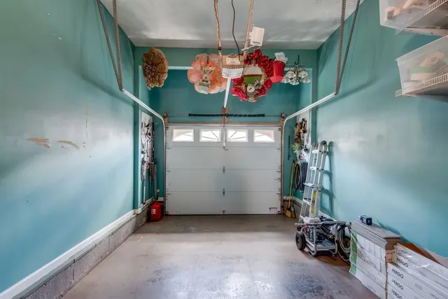 a view of a patio with chairs and table under an umbrella
