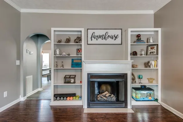 a living room with a book shelf and a table