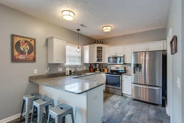 a kitchen with refrigerator a stove a sink and a refrigerator