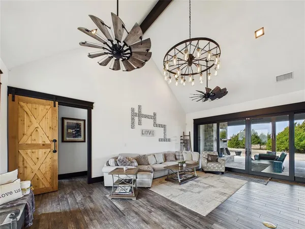 a living room with furniture a window and a chandelier