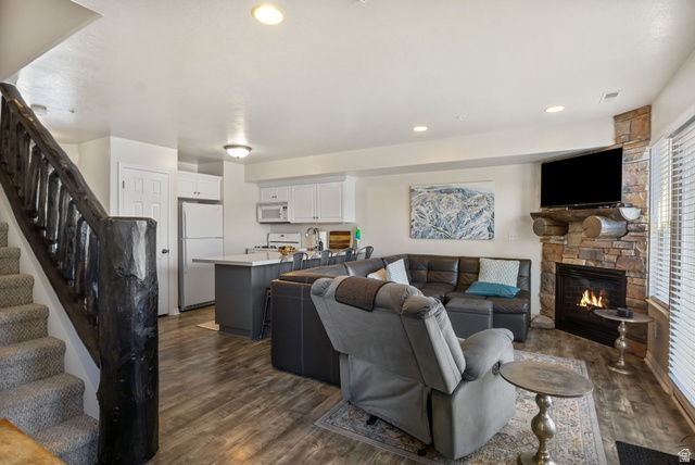 3598 North Huntsman Path, Unit 502 Eden, UT 84310 - Photo 6 of 43 Living room with dark wood-style flooring, a stone fireplace, and recessed lighting