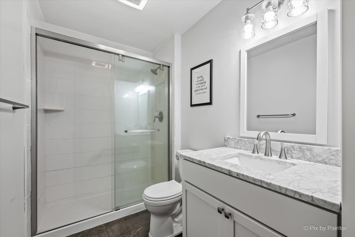 7104 Dove Way Cary, IL 60013 - Photo 38 of 82 a bathroom with a granite countertop sink toilet and shower