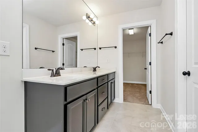 a bathroom with a double vanity sink mirror and shower