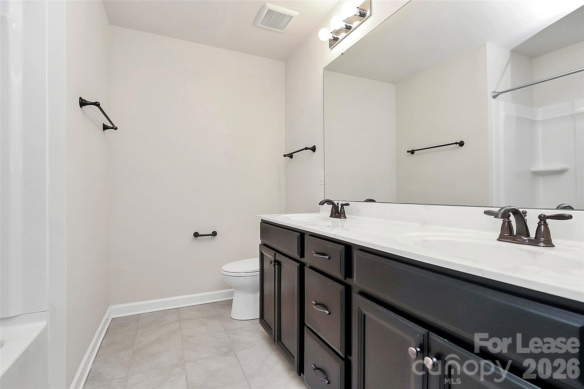 5688 Garrow Glen Road Charlotte, NC 28278 - Photo 14 of 17 a bathroom with a granite countertop sink a toilet and a mirror