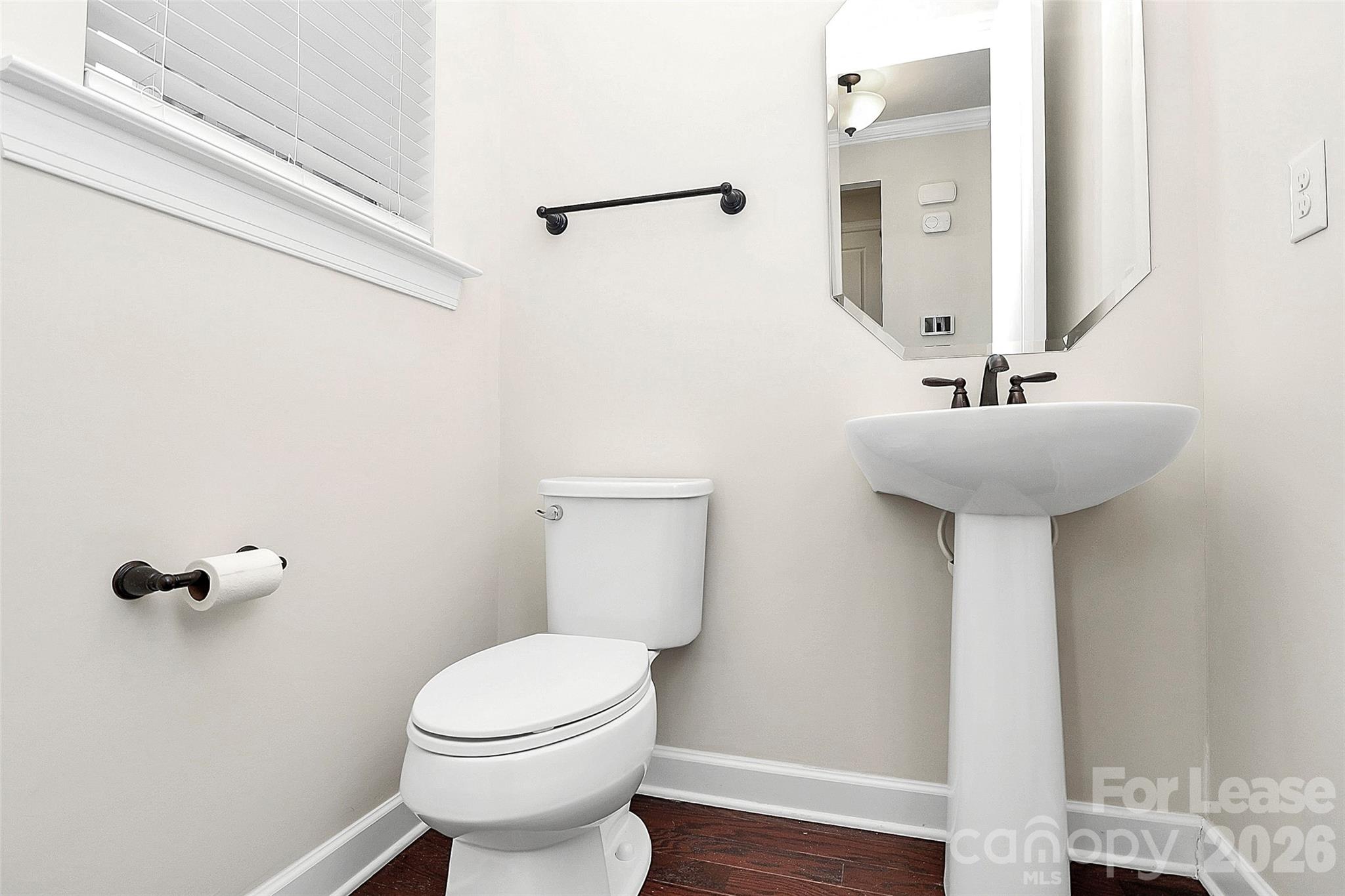 5688 Garrow Glen Road Charlotte, NC 28278 - Photo 6 of 17 a bathroom with a sink toilet and a mirror