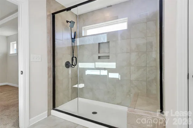 a bathroom with a glass shower door