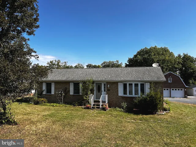 a front view of a house with a yard table and chairs