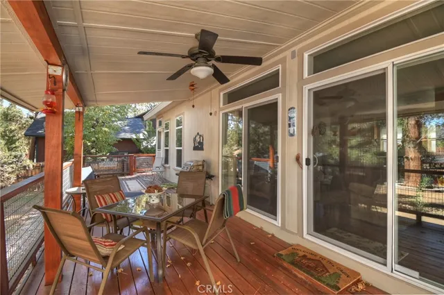 a view of a porch with dining table and chairs