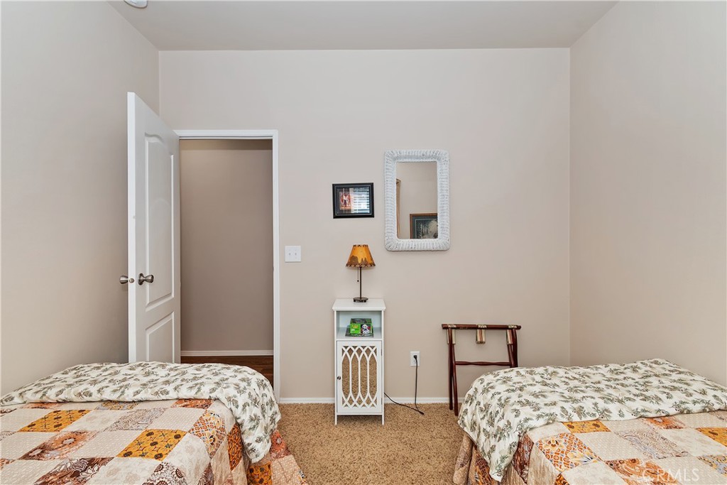 775 Riverside Avenue Sugarloaf, CA 92386 - Photo 26 of 32 a bedroom with a bed and a table