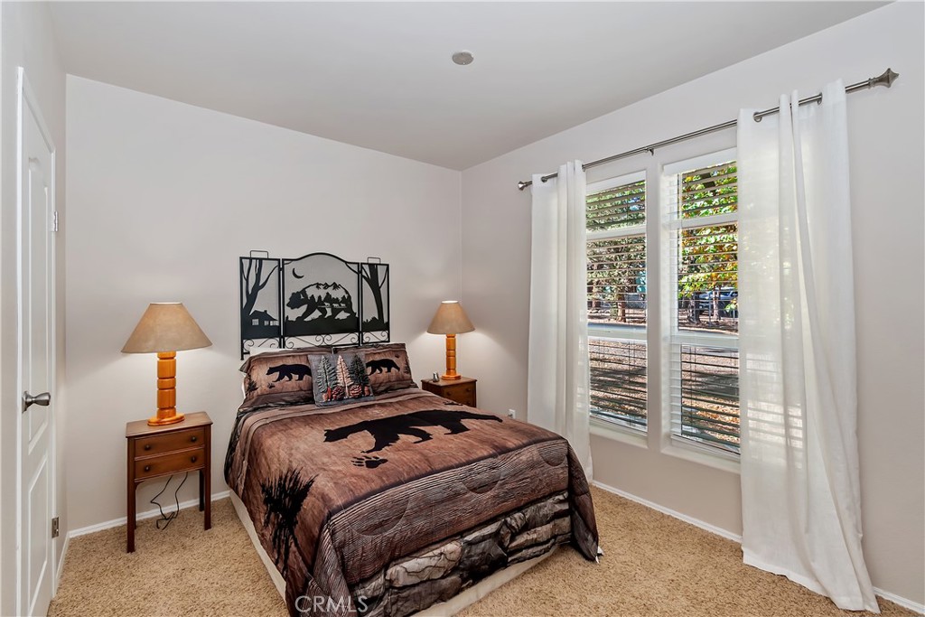 775 Riverside Avenue Sugarloaf, CA 92386 - Photo 28 of 32 a bedroom with a bed and a window