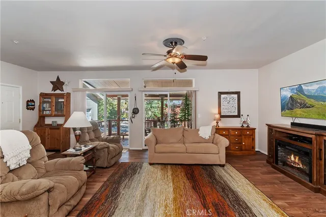 a living room with furniture a fireplace and a flat screen tv