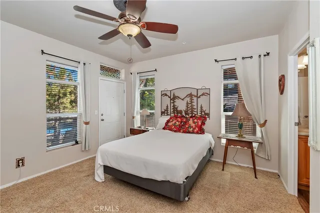 a bedroom with a bed next to a window