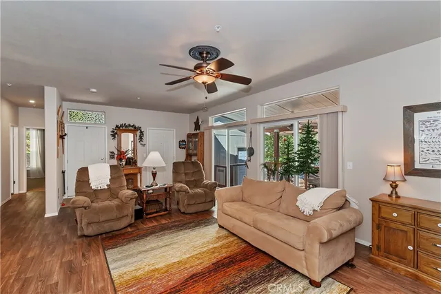 a living room with furniture ceiling fan and a window