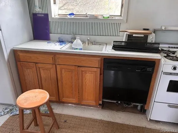 a kitchen with stainless steel appliances wooden cabinets and a table
