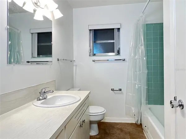 a bathroom with a sink mirror and shower