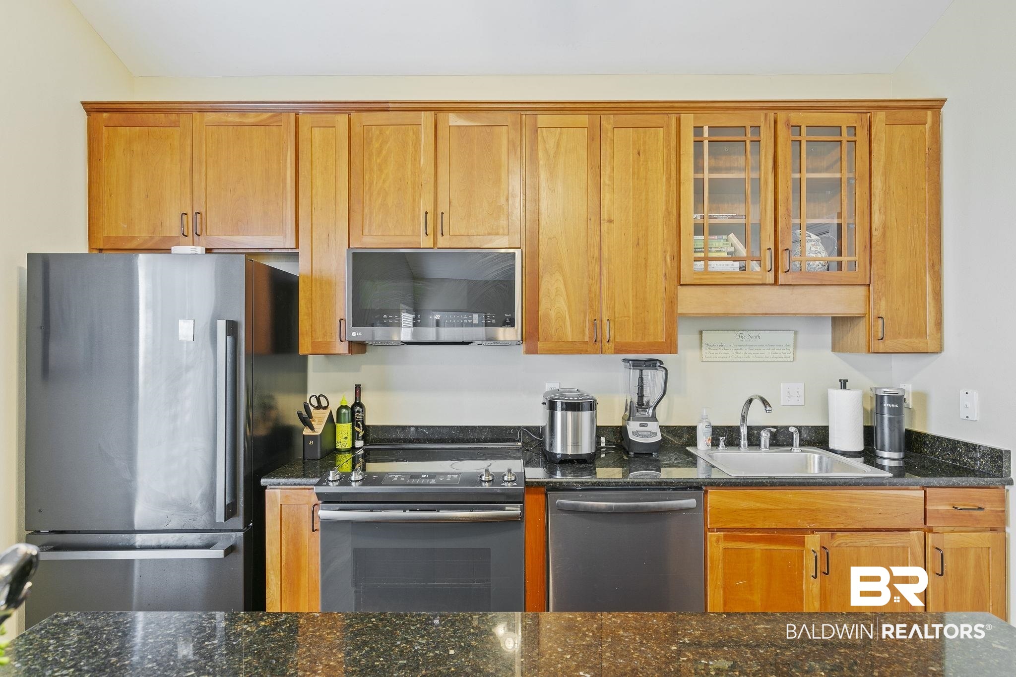 17341 Cabin Road Loxley, AL 36551 - Photo 22 of 49 Kitchen with dark stone counters, sink, and appliances with stainless steel finishes