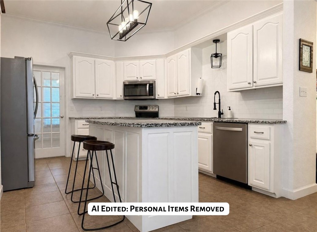 70 Walthall Road Russellville, AR 72802 - Photo 8 of 51 Modern kitchen featuring white cabinetry, dark speckled countertops, stainless steel appliances, and a white subway tile backsplash