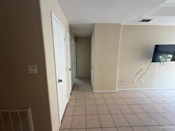a view of a livingroom with an empty space and a window