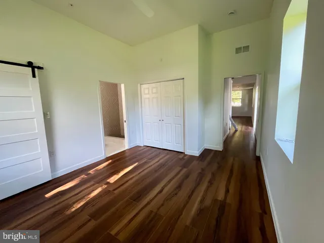 a view of an empty room and wooden floor