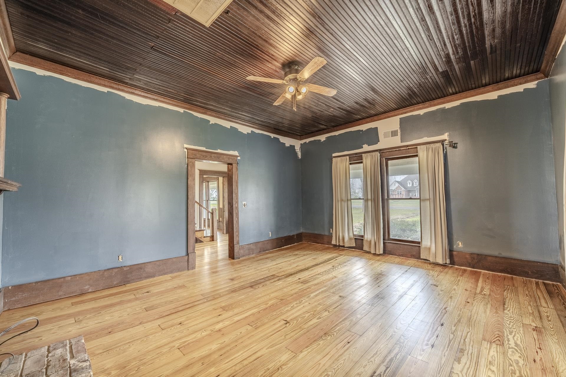 2055 Kendrick Road Michie, TN 38357 - Photo 17 of 37 a view of an empty room with wooden floor and a window