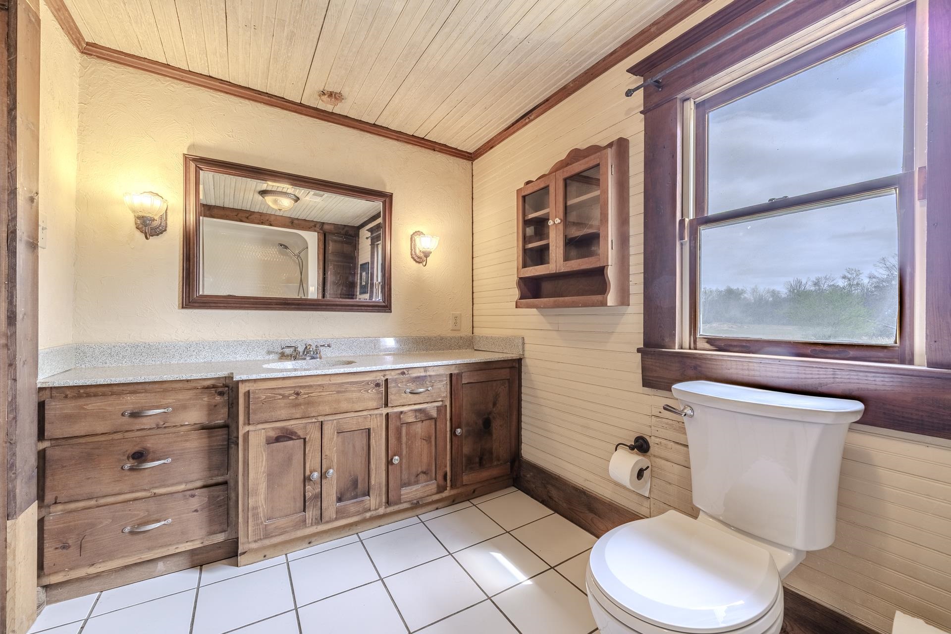 2055 Kendrick Road Michie, TN 38357 - Photo 25 of 37 a spacious bathroom with a toilet sink and mirror
