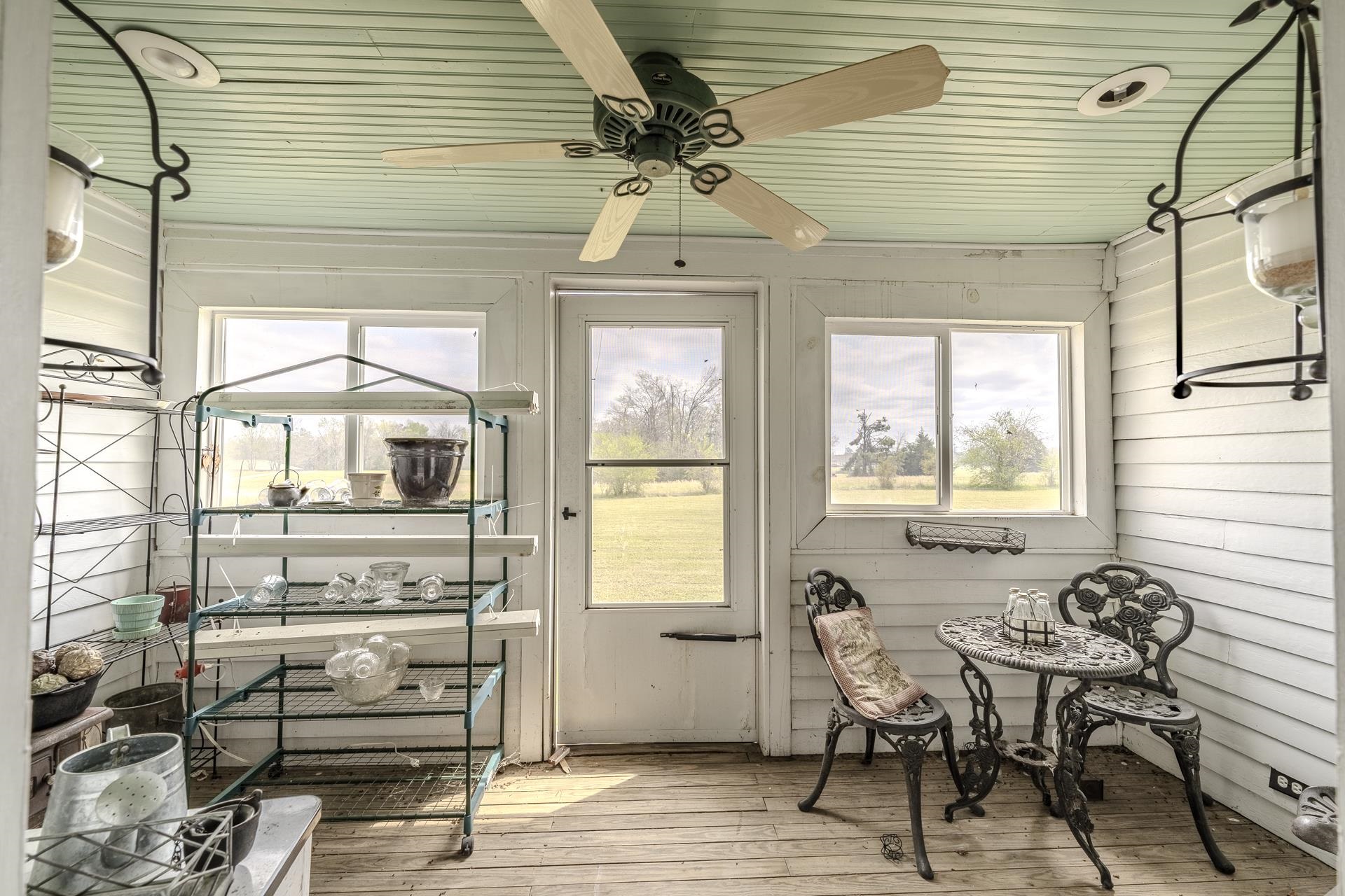 2055 Kendrick Road Michie, TN 38357 - Photo 26 of 37 a dining room with wooden floor a chandelier a glass table and chairs