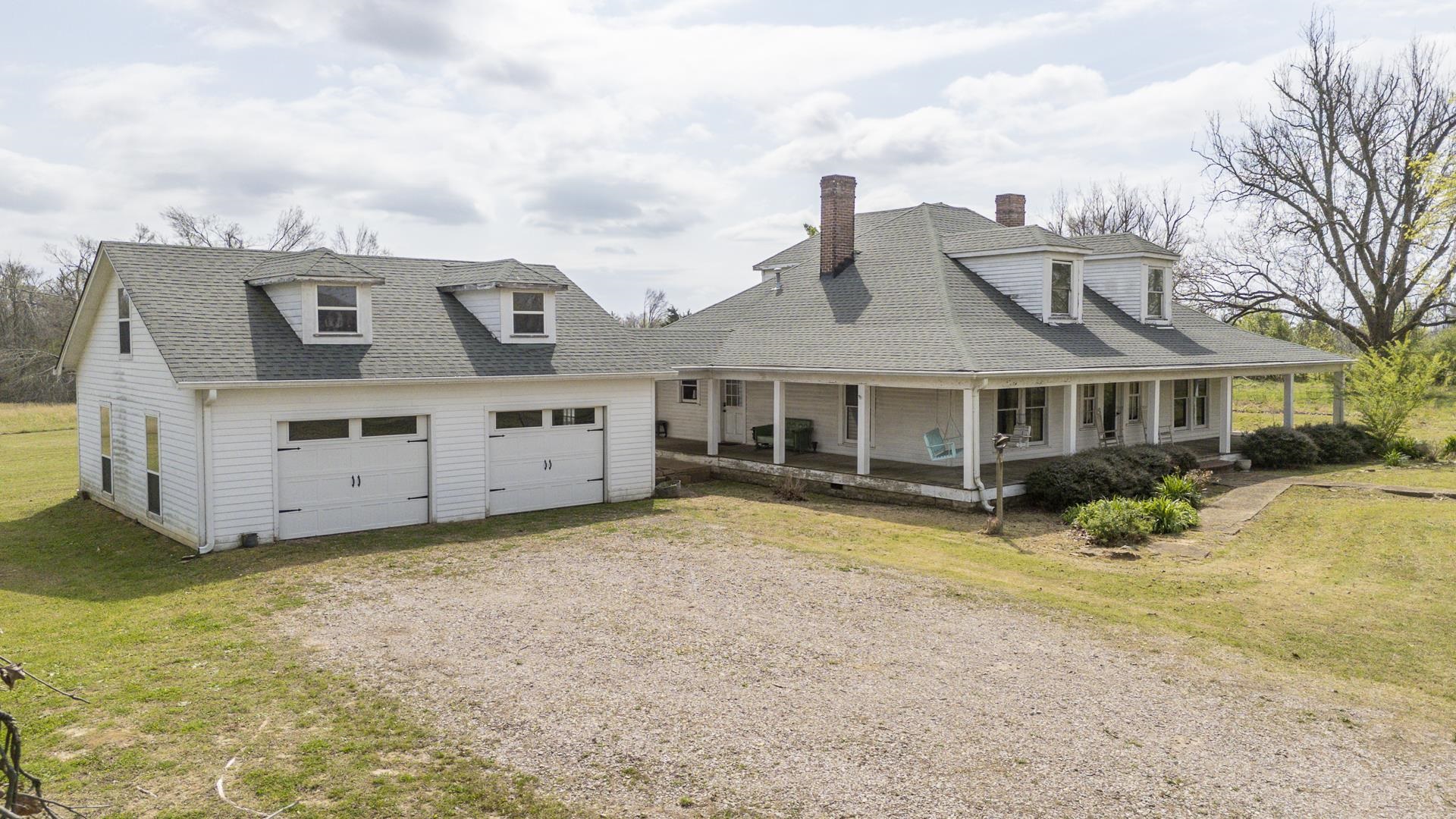 2055 Kendrick Road Michie, TN 38357 - Photo 4 of 37 a front view of a house with a big yard and large trees