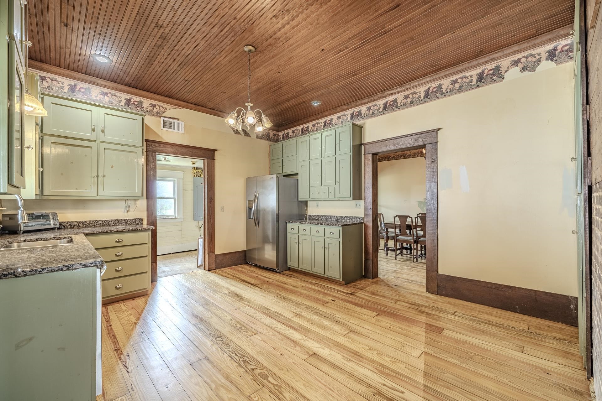 2055 Kendrick Road Michie, TN 38357 - Photo 6 of 37 a view of a kitchen with a refrigerator and a stove top oven