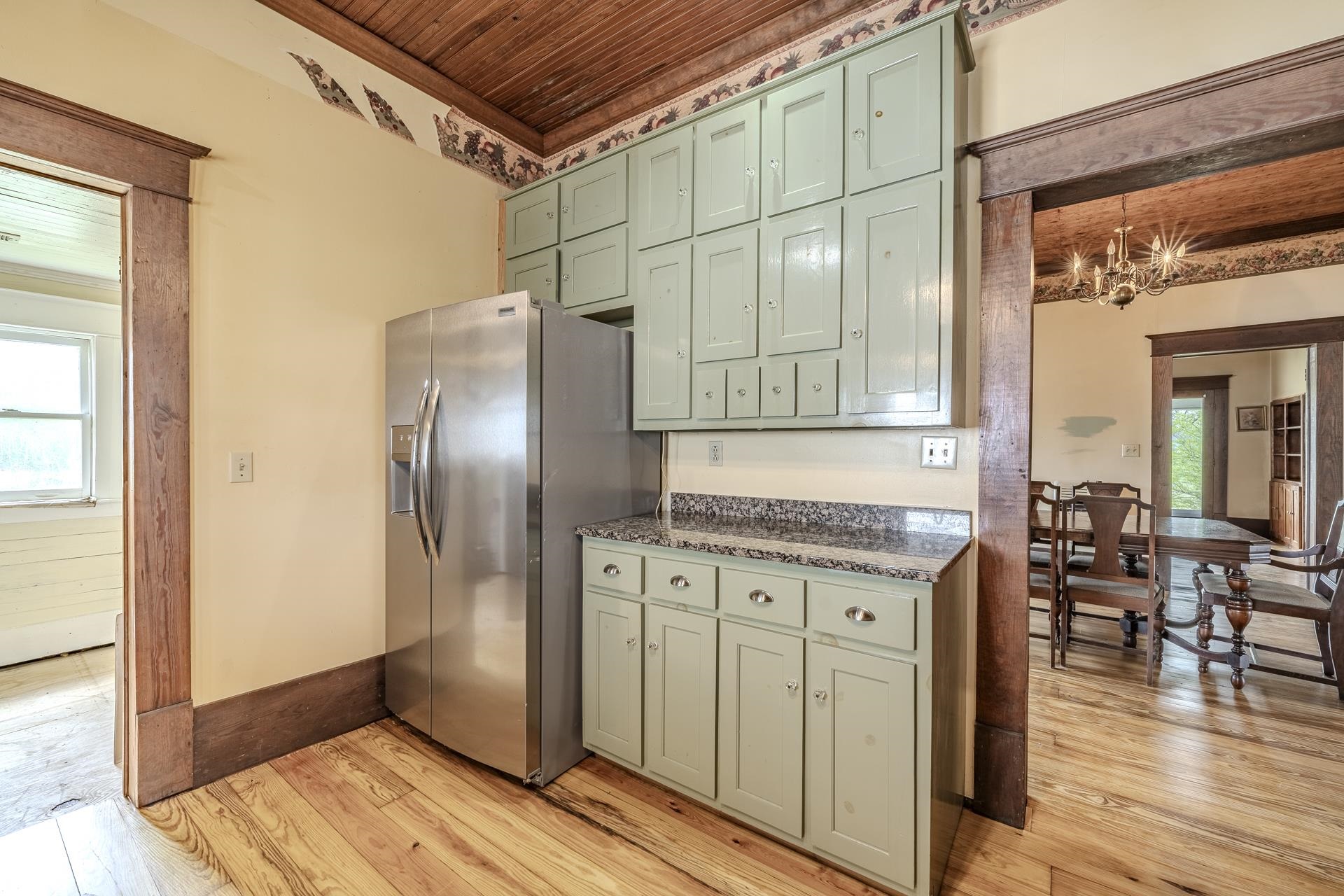 2055 Kendrick Road Michie, TN 38357 - Photo 9 of 37 a kitchen with granite countertop a refrigerator and a stove top oven