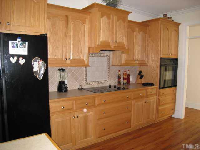 1010 Redleaf Lane Rougemont, NC 27572 - Photo 5 of 11 a kitchen with stainless steel appliances granite countertop a refrigerator a stove top oven and a sink with wooden floor