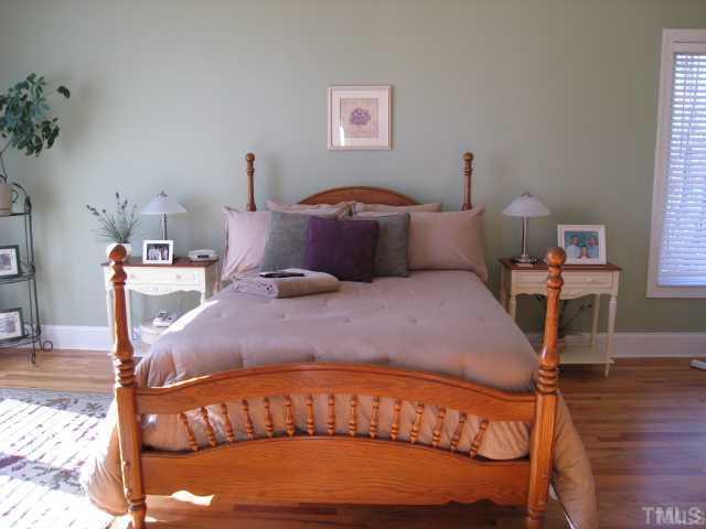 1010 Redleaf Lane Rougemont, NC 27572 - Photo 7 of 11 a bed sitting in a bedroom next to a window with a bookshelf