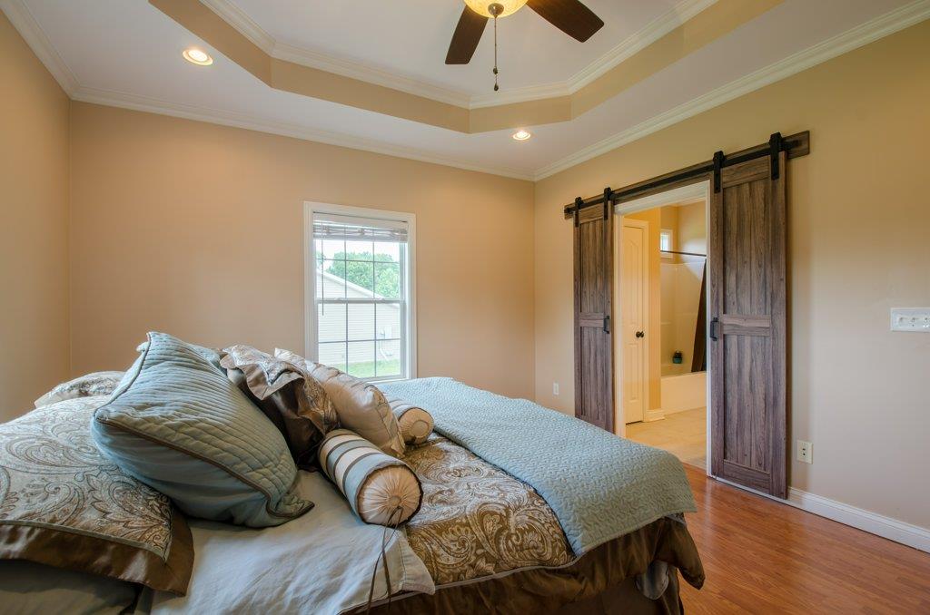 962 Mt Vernon Road Bethpage, TN 37022 - Photo 12 of 23 a bedroom with a bed and wooden floor
