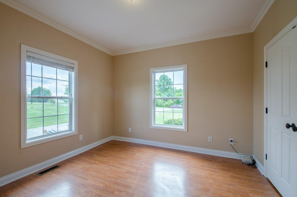 962 Mt Vernon Road Bethpage, TN 37022 - Photo 17 of 23 an empty room with wooden floor and windows