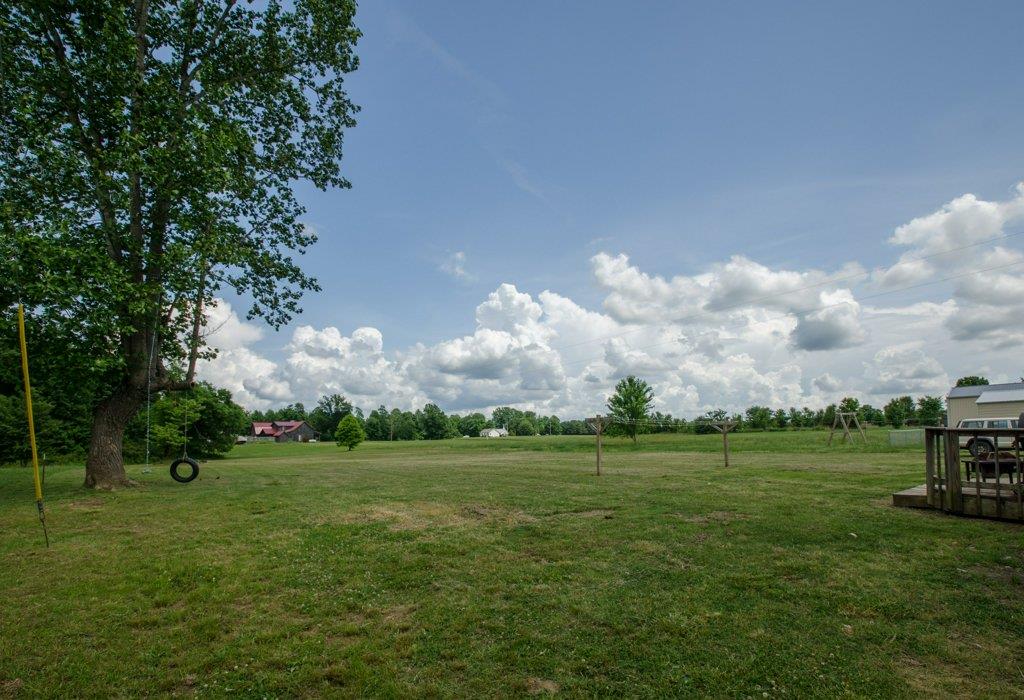 962 Mt Vernon Road Bethpage, TN 37022 - Photo 22 of 23 a backyard of a house with lots of green space table and chairs