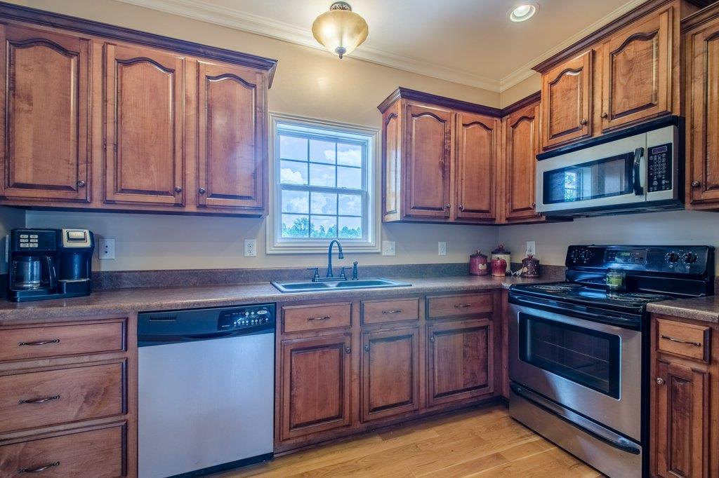 962 Mt Vernon Road Bethpage, TN 37022 - Photo 6 of 23 a kitchen with stainless steel appliances granite countertop a stove microwave and cabinets