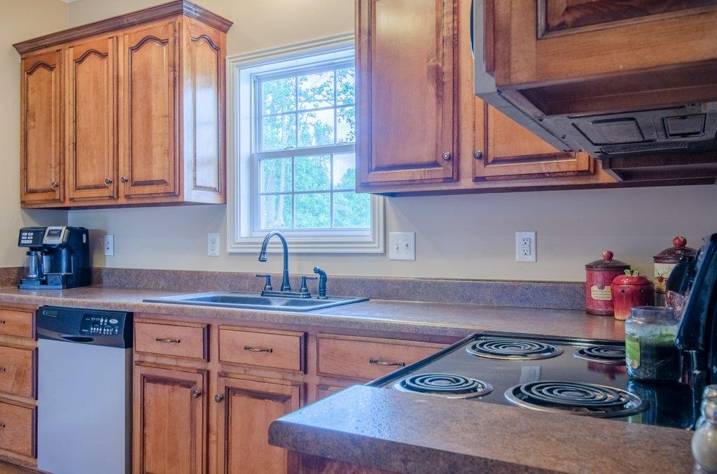 962 Mt Vernon Road Bethpage, TN 37022 - Photo 7 of 23 a kitchen with stainless steel appliances granite countertop a sink stove and cabinets