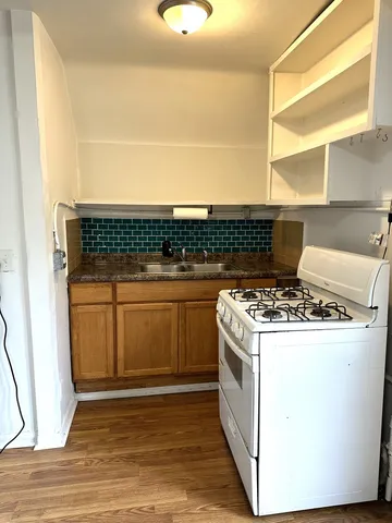 a stove top oven sitting inside of a kitchen